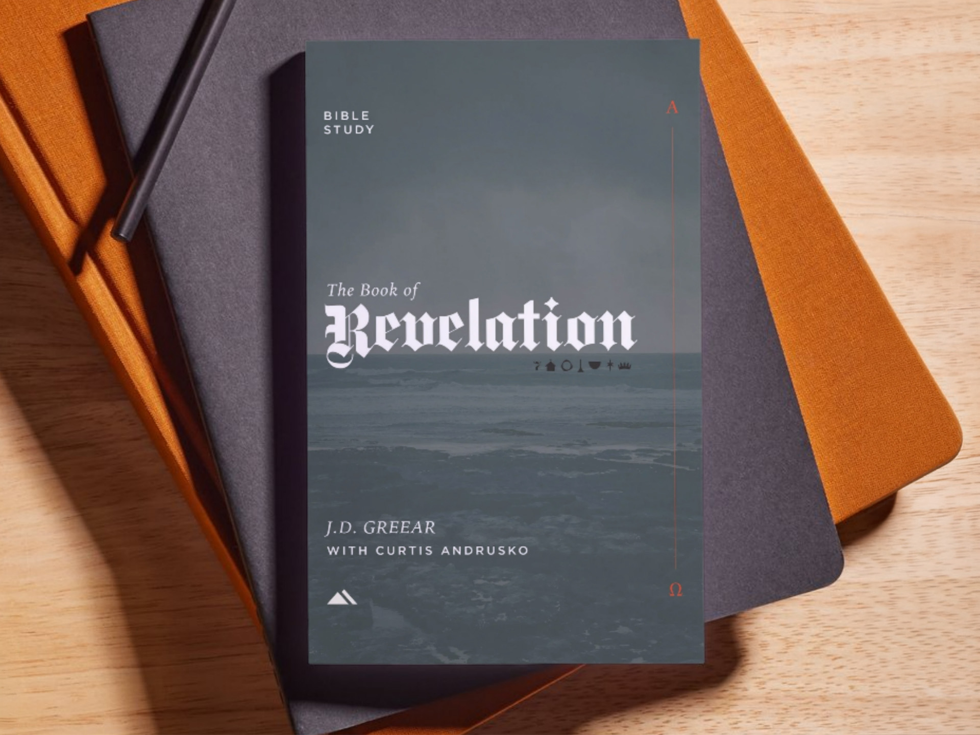The Book of Revelation — a printed Bible study from J.D. Greear with Curtis Andrusko, shown on a desk
